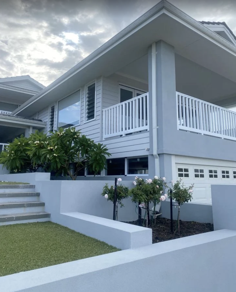 Freshly painted two-storey weatherboard home in Berwick, Melbourne — full exterior view from garden to roofline after a recent repaint by Northern Star Painting